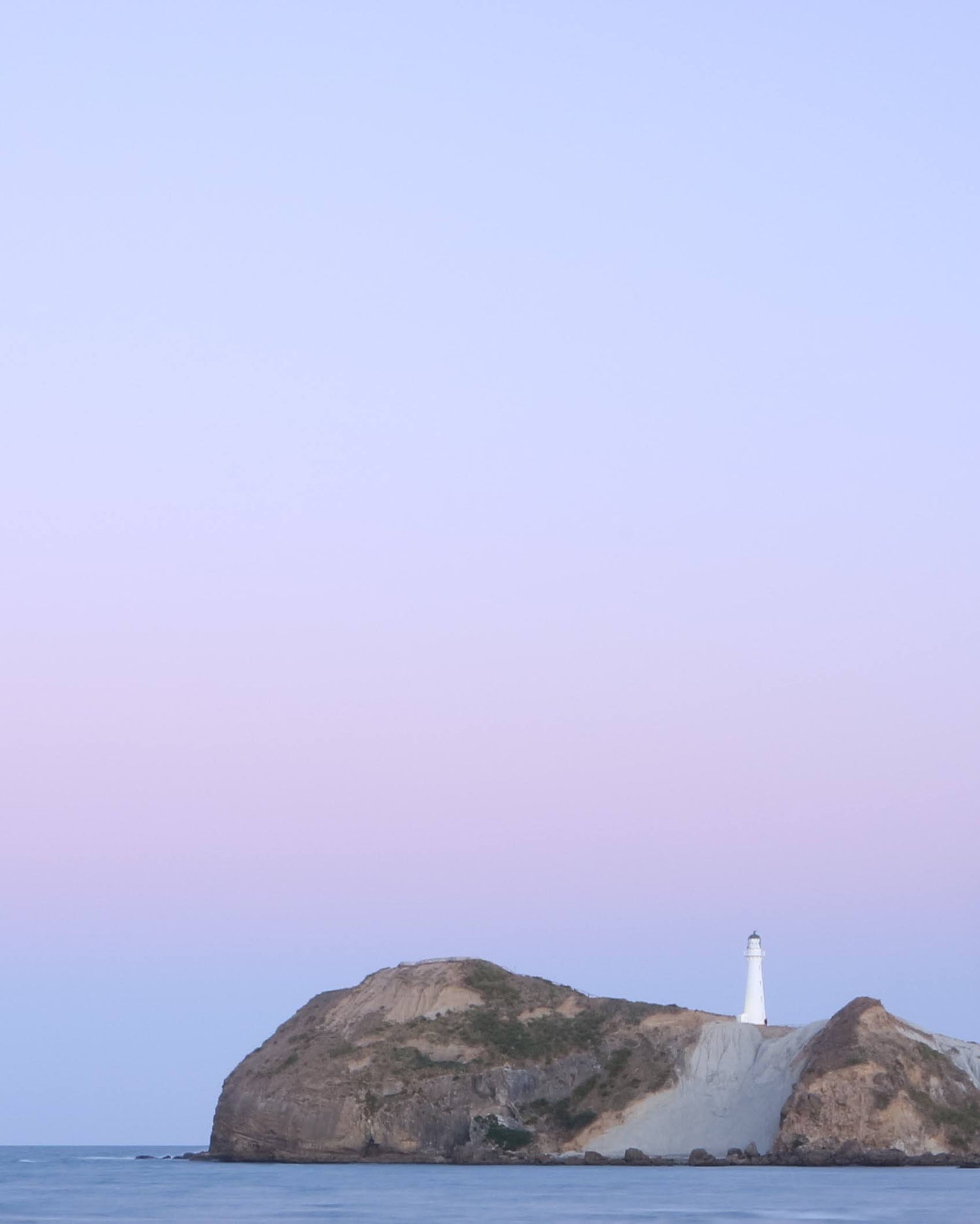 Castlepoint lighthouse at sunset cropped tightly as a portrait picture to preview the full landscape panorama style photo